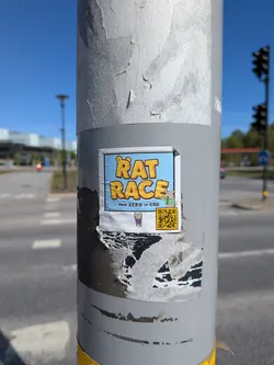 Street sticker A rectangular sticker featuring a light blue background with subtle white cloud-like elements. The prominent text "RAT RACE" is displayed in large, bold, yellow letters with a dark orange outline, where the 'R' in 'RAT' has a small ear-like bump. Below this, in smaller dark text, reads "FROM ZERO TO CEO". To the right of the smaller text, a cartoon mouse character in a green jacket points towards the right. On the bottom left, another small purple cartoon mouse hangs from an unseen element. A clear yellow QR code with black modules is positioned on the bottom right. The sticker has a white border and is affixed to a grey pole, showing some wear and tear around its edges.