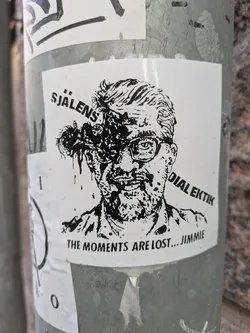 Street sticker Black and white sticker featuring a stylized illustration of a man with insects crawling out of his head. Text on the sticker includes "Sjalens Dialektik" and "The Moments Are Lost... Jimmie".