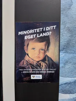 Street sticker A rectangular political sticker featuring a classic painting of a crying, blue-eyed boy. Bold white Swedish text is positioned above and below the portrait. A small logo for 'Alternativ för Sverige' with a Swedish flag heart is at the bottom.
