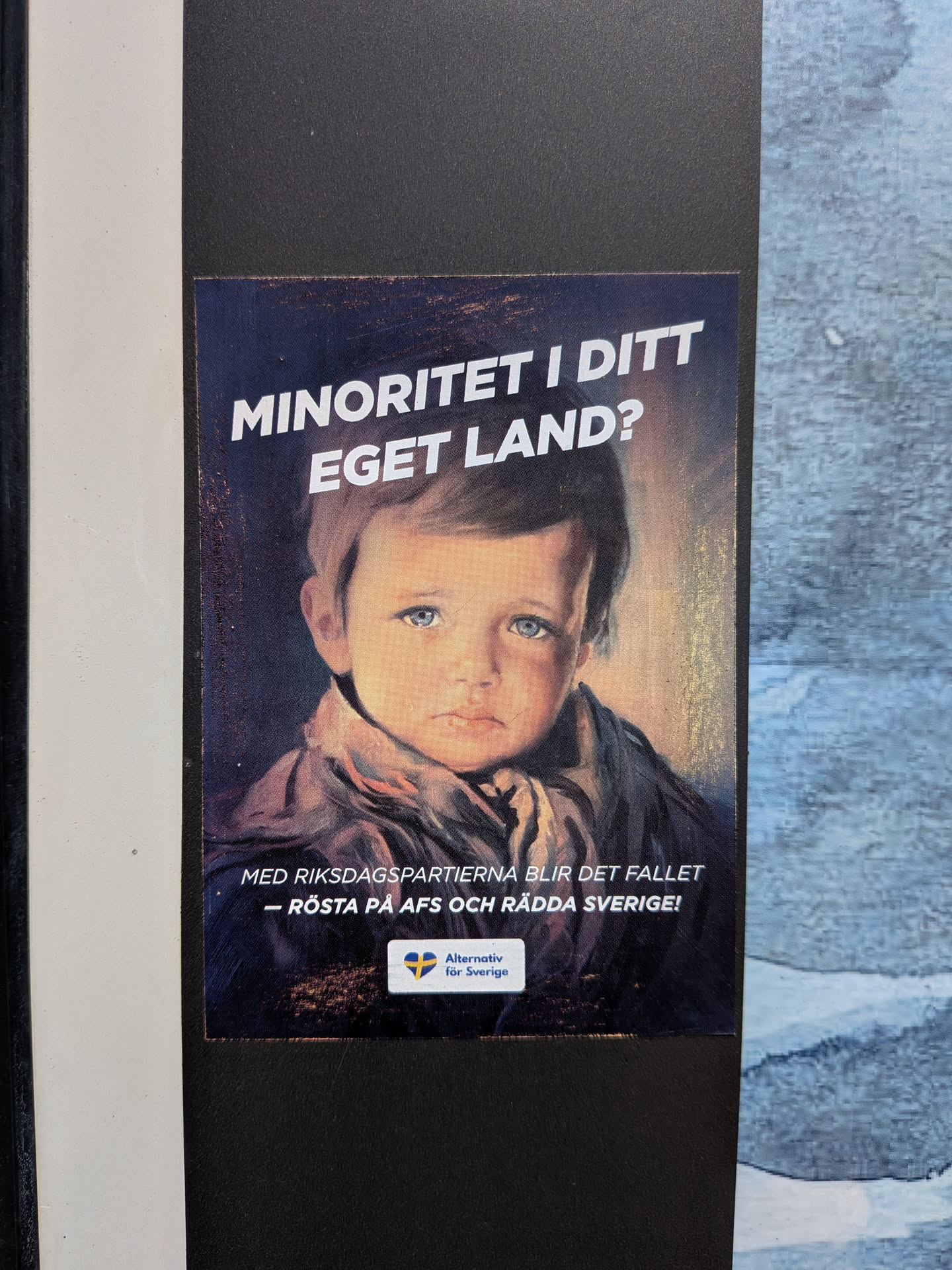 A rectangular political sticker featuring a classic painting of a crying, blue-eyed boy. Bold white Swedish text is positioned above and below the portrait. A small logo for 'Alternativ för Sverige' with a Swedish flag heart is at the bottom.