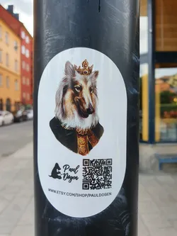 Street sticker Oval sticker featuring a majestic Collie dog wearing a crown, depicted in a regal portrait style.  The sticker includes the artist's logo, name (Paul Dogen), and a QR code linking to their Etsy shop.