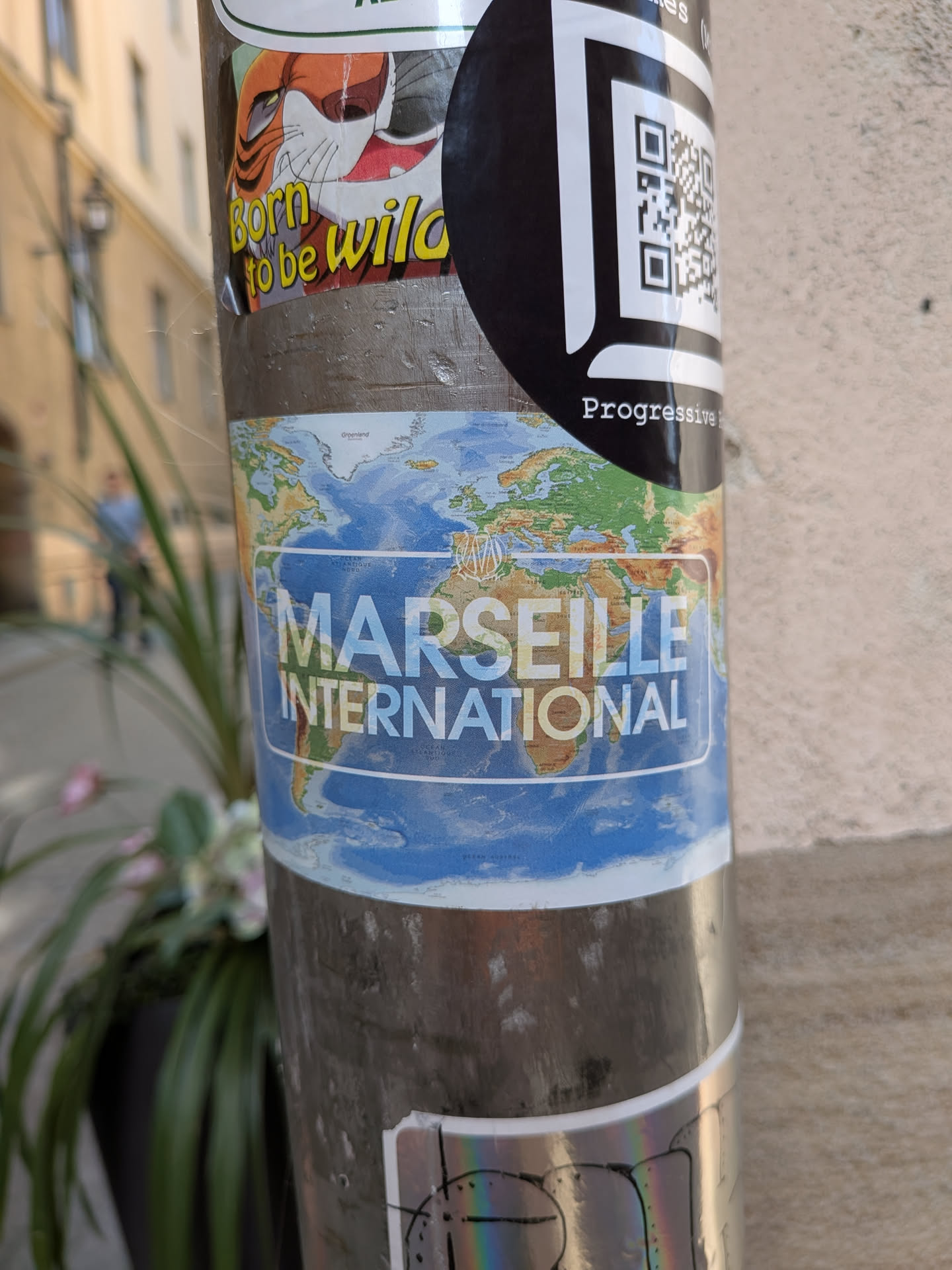 A rectangular sticker showing a world map. The text 'MARSEILLE INTERNATIONAL' is printed in bold white across the center, accompanied by a small gold OM football club logo above it.