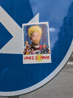 Rectangular sticker parodying the 'Sunes sommar' movie poster. Features a central man with edited yellow hair and beard, surrounded by characters from the film. The text 'UNES SOMMAR' is printed at the bottom in red with a yellow sun.