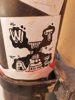 A black and white sticker featuring a stylized design with the letters W, I, T, A, Z arranged around a central figure resembling a spray paint can.  The text 'RTS-PNR' is visible near the bottom.