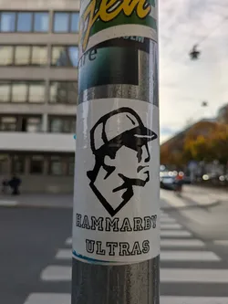 Black and white sticker with a stylized illustration of a person wearing a baseball cap.  The text 'HAMMARBY ULTRAS' is printed underneath the illustration.