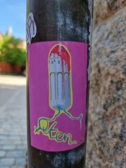 This sticker features an illustration of a tampon with a castle-like structure on top, dripping red paint. The word "often" is written underneath in a stylized font. It's a vibrant and bold piece that's both provocative and artistic. The style is reminiscent of protest art with a touch of dark humor. 