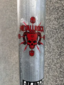 Street sticker A red and white sticker featuring a skull with horns and pentagram, along with the text 'Metallrock Shop'.