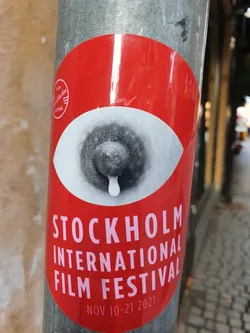 A red circular sticker featuring a stylized eye with a single tear, promoting the Stockholm International Film Festival, which took place from November 10-21, 2021. 