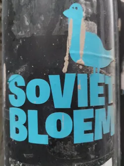 Street sticker A weathered sticker with the words "Soviet Bloem" in teal lettering on a black background.  A simple teal bird graphic is positioned above the text.