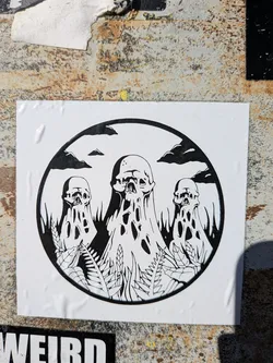 Street sticker The sticker features a circular, black-bordered illustration on a white rectangular background. Inside the circle, three skull-like figures dominate the scene, rendered in black and white. The central figure is the largest, with two smaller ones on either side. All three appear to be melting or dripping downwards, forming elongated, organic shapes with irregular holes and voids, giving them a ghostly or decaying appearance. The skulls have visible eye sockets and nasal cavities. The base of the figures and the foreground are filled with black silhouettes of various plant life, resembling grass and ferns. In the upper portion of the circle, against the white background, are dark, stylized clouds and small, distant hill-like shapes, all rendered in black. The overall aesthetic is dark, macabre, and surreal, utilizing only black and white tones.