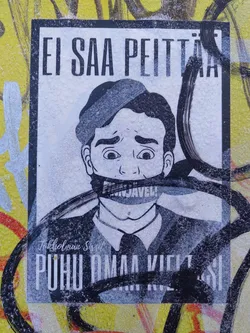 Street sticker A sticker featuring a black and white illustration of a man with his mouth taped shut, with the text "Ei saa peittää" (Can't hide) at the top and "Puhu omaa kieltäsi" (Speak your own language) at the bottom. The sticker has a grunge and rebellious style. The man's mouth is covered with tape that says "Sensuuri".