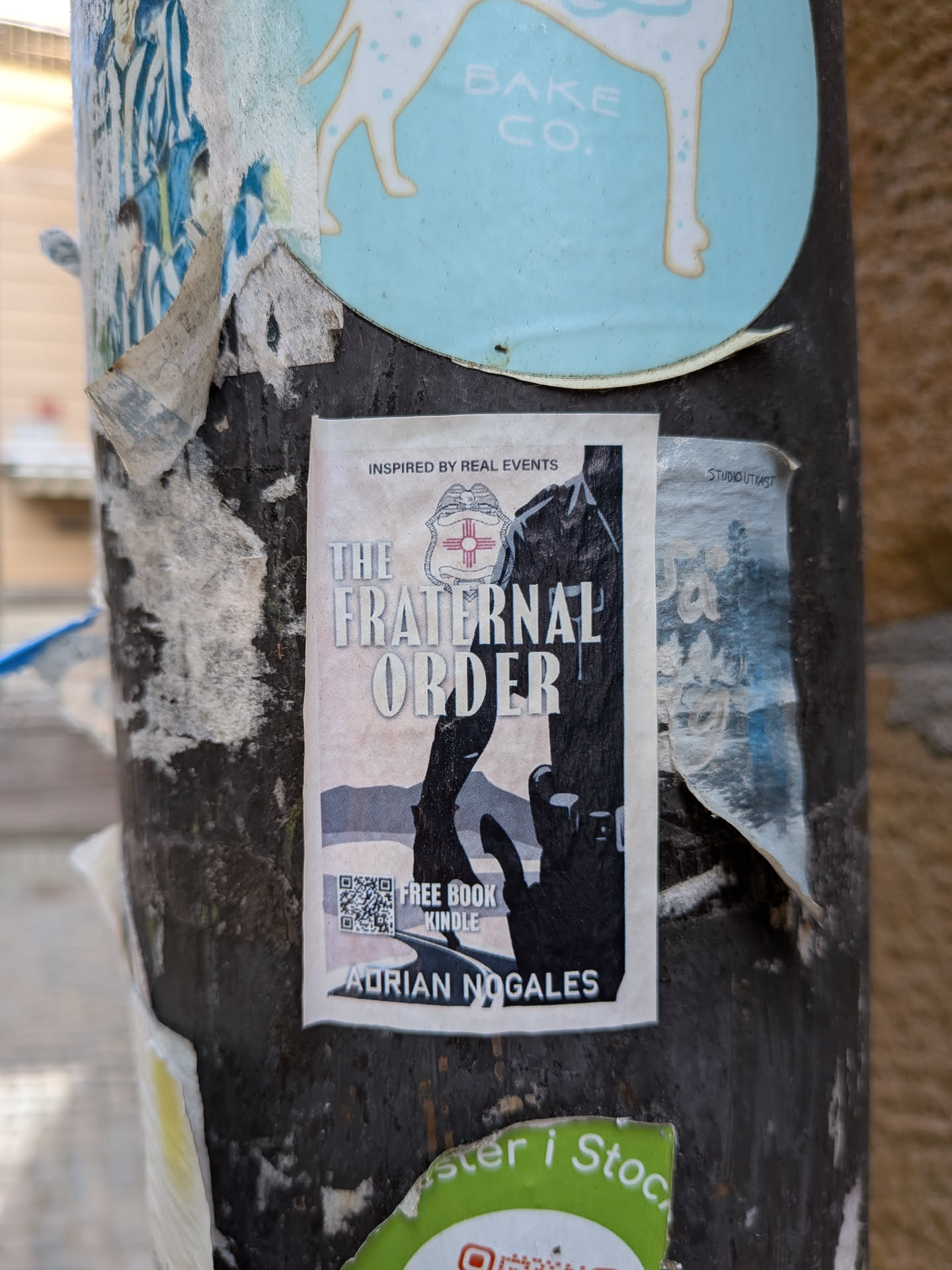 A rectangular sticker displaying a book cover design. It features a dark silhouette of a police officer, a highway, and a police badge with a red Zia symbol. Text includes the title, author name, and a QR code.