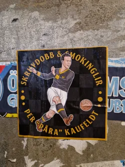 Street sticker A sticker featuring an illustration of Per "Påra" Kaufeldt, a soccer player, with text that says "Skryddobb & Smokinglir" around the illustration. The background is a checkered pattern.