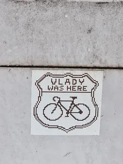 Street sticker A pixel art sticker depicting a bicycle inside a shield with the text "Vladyslav was here".