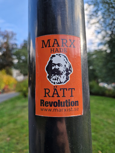 Street sticker An orange sticker with a picture of Karl Marx. The text on the sticker says "Marx hade rätt" which translates to "Marx was right" in Swedish. It also says "Revolution" and provides a website address: www.marxist.se