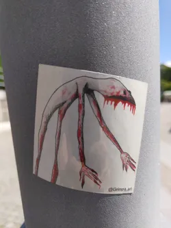 Street sticker A sticker featuring a drawing of a tall, slender humanoid creature with long limbs and red dripping from its mouth. The creature has a pale complexion and clawed hands.  The artist's Instagram handle is visible at the bottom.