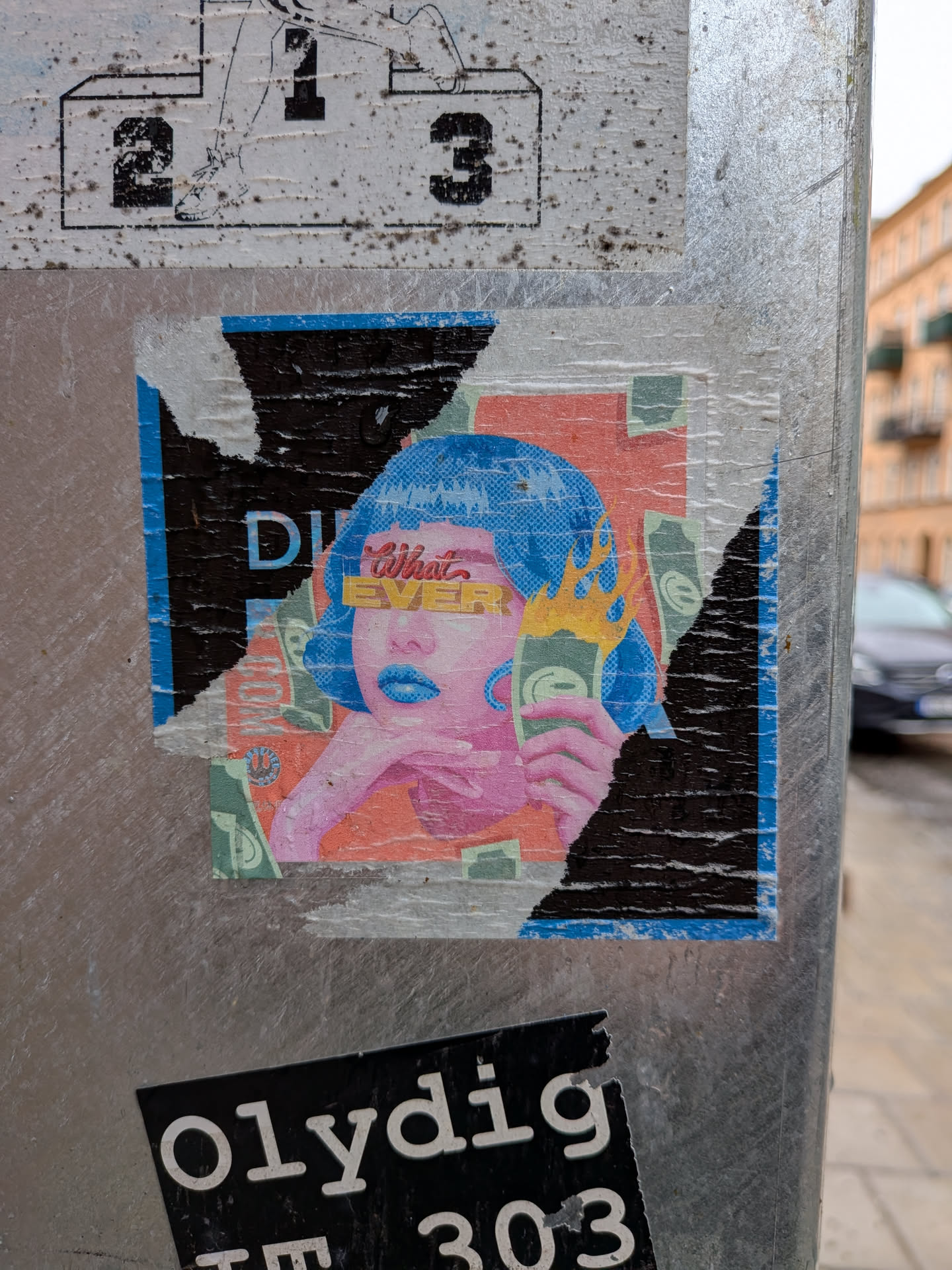 The sticker depicts a stylized portrait of a woman with short, bright blue hair rendered with a halftone dot pattern. Her skin is a light pinkish-purple, and her lips are a glossy blue. Her eyes are obscured by a yellow bar with the word 'What' in red script above it and 'EVER' in bold yellow block letters. She rests her chin on her hand. In her other hand, she holds a green banknote with a Euro-like symbol, from which yellow and orange flames appear to emanate. The background is a collage of orange, green, and black elements, with more green banknotes scattered around. The overall style is reminiscent of pop art or comic book aesthetics. The sticker itself is distressed, with significant tears and peeling, especially on the left and right sides, revealing black and blue borders.
