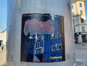 A sticker featuring a geometric design reminiscent of a building, overlaid on a picture of a building. The text "РАПС РАПС РАПС РАПС РАПС" is repeated at the top. The sticker includes the Instagram handle @rapperpam at the bottom.