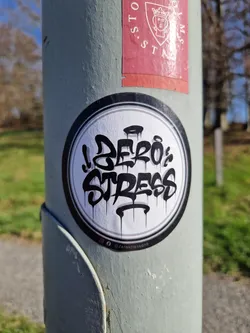 Street sticker Round sticker with black graffiti art on white background. The text 'Zero Stress' is written in a stylized font with dripping paint effect.  There is an Instagram handle at the bottom.