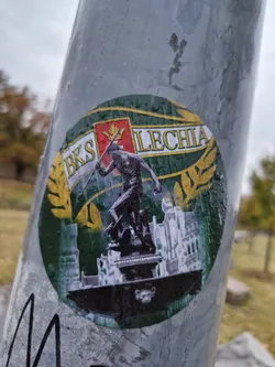 A round sticker depicting the logo of BKS Lechnia. The logo includes a green background with golden accents, a statue, and text that says "BKS LECHIA".