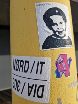 Street sticker A rectangular white sticker featuring a black high-contrast stencil portrait of Margaret Thatcher wearing a beret with a star, parodying the iconic Che Guevara portrait. The word 'BADDABOOM' is printed at the top, and 'BADDABING' is printed in the bottom right corner.