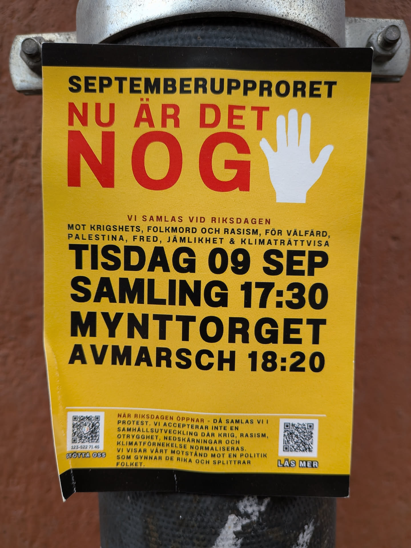 Street sticker The sticker is predominantly bright yellow with bold, black and red text. At the top, it reads 'SEPTEMBERUPPRORET' in black. Below that, 'NU ÄR DET' is in red, followed by a large red 'NOG' and a white open palm graphic. The middle section lists reasons for gathering: 'VI SAMLAS VID RIKSDAGEN MOT KRIGSHETS, FOLKMORD OCH RASISM, FÖR VÄLFÄRD, PALESTINA, FRED, JÄMLIKHET & KLIMATRÄTTSVISA'. The date and time are clearly stated: 'TISDAG 09 SEP SAMLING 17:30 MYNTTORGET AVMARSCH 18:20'. The bottom section contains two QR codes, one with text '123-522 71 45 STÖTTA OSS' and the other with 'LÄS MER'. Below the QR codes, there is a block of smaller text detailing the purpose of the protest.