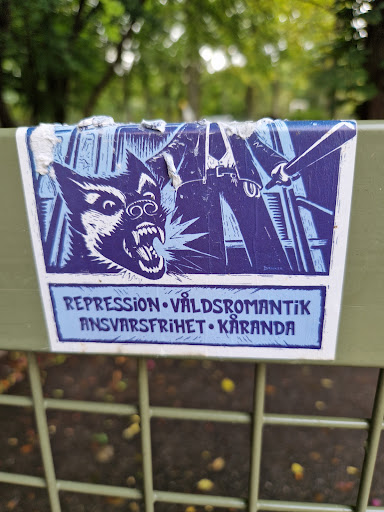 Street sticker A sticker depicting a snarling dog confronting a figure wielding a baton.  The text below the image reads "Repression • Väldsrömantik Ansvarsfirhet • Käranda". The style is reminiscent of protest art or printmaking.