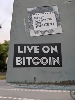 A rectangular black sticker featuring the text 'LIVE ON BITCOIN' in white. 'LIVE ON' is in a bold sans-serif font, while 'BITCOIN' is in a stylized inline font.