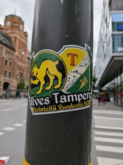 Street sticker A die-cut sticker featuring the yellow Ilves lynx logo on a green circle, paired with the Tampere coat of arms shield. Text below reads 'Ilves Tampere' and 'Perinteitä Vuodesta 1931' on a black background.