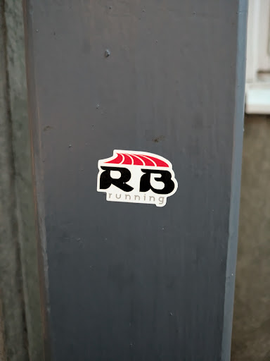 Street sticker A sticker featuring the RB Running logo, which includes stylized letters RB with a red wave-like design above them. The text "running" is present beneath the logo.