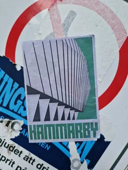 Street sticker A sticker with a minimalist design depicting a building's facade with a color scheme of white, black, and green.  The word 'HAMMARBY' is prominently displayed at the bottom. The style is geometric and architectural.
