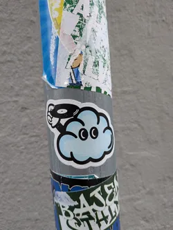 Street sticker A die-cut sticker featuring a stylized, light-blue cartoon cloud with large black eyes. A cartoon hand emerges from the left side, holding a black vinyl record. The sticker has a thick black outline and a white border.