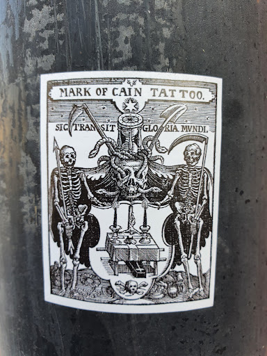 Street sticker MARK OF CAIN TATT0. SIC TRAN SIT GLO RIA MVNDI.