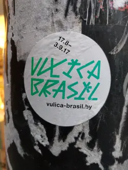 Round white sticker with green text. The text says "Vulca Brasil" in a stylized font.  There are also some small numbers and date written on the sticker, "17.8- 3.9.17", possibly indicating creation or release date. Below the main text, there is a website address: vulica-brasil.by