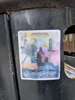 Street sticker A rectangular sticker with a white border featuring a faded, watercolor-style image. It depicts a central bottle silhouette, a windmill structure on the left, and a tower on the right, rendered in bleeding blue, pink, and yellow tones.