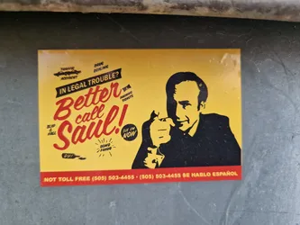 Street sticker A yellow and black sticker featuring Saul Goodman from the TV show Better Call Saul.  It includes his phone number and mentions various legal issues like traffic accidents and parking tickets. The text is stylized to look like a vintage advertisement.