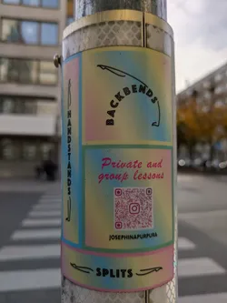 Street sticker Sticker promoting yoga classes focusing on backbends, handstands and splits.  The sticker has a pastel color scheme and includes a QR code linking to the instructor's Instagram profile.