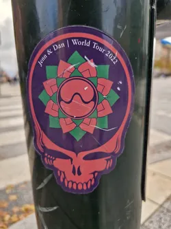 Sticker featuring a skull and a mandala design.  Text on the sticker reads "Jenn & Dan | World Tour 2022".