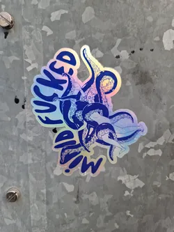 Holographic sticker of an octopus with the text "Wicked Squid!" in blue. The sticker has an iridescent finish.