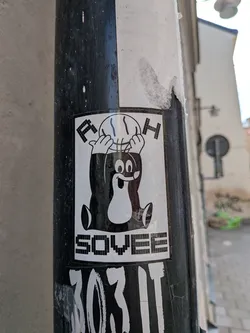 Street sticker A rectangular black and white sticker featuring the Czech cartoon mole Krtek holding a basketball overhead. The pixelated letters 'F' and 'H' flank the ball, and the word 'SOVEE' is printed at the bottom.