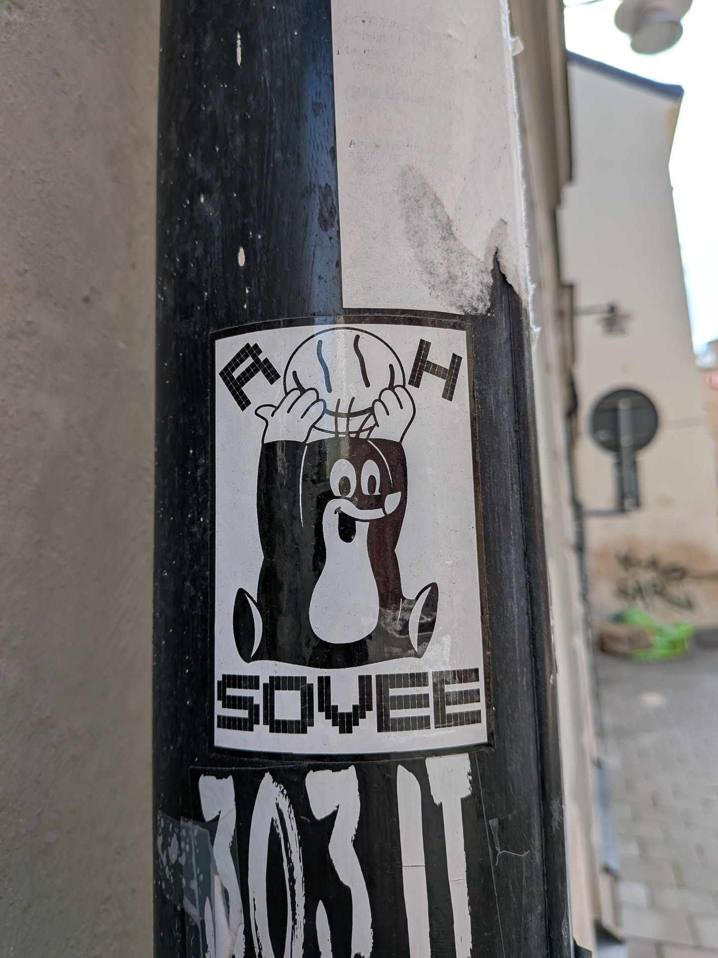 A rectangular black and white sticker featuring the Czech cartoon mole Krtek holding a basketball overhead. The pixelated letters 'F' and 'H' flank the ball, and the word 'SOVEE' is printed at the bottom.