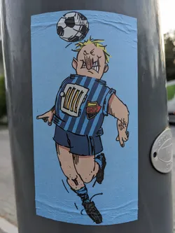 Street sticker The sticker features a hand-drawn illustration of a cartoonish soccer player with exaggerated features. He's depicted in mid-air, heading a soccer ball. The style is reminiscent of comic books or graphic novels. The player's jersey is blue with a unique design featuring a radiator graphic and the acronym "DIP." The overall color palette is simple, using mainly blues and light tones.