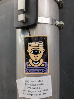 Street sticker A rectangular sticker depicting a tan cyclops character with a camera-shaped head. The character floats in a purple ring labeled 'COTSY' against a dark, dotted background.