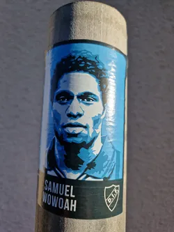 Street sticker A blue and white sticker featuring a stylized portrait of Samuel Wowoah, a footballer. The sticker includes his name and a club logo.