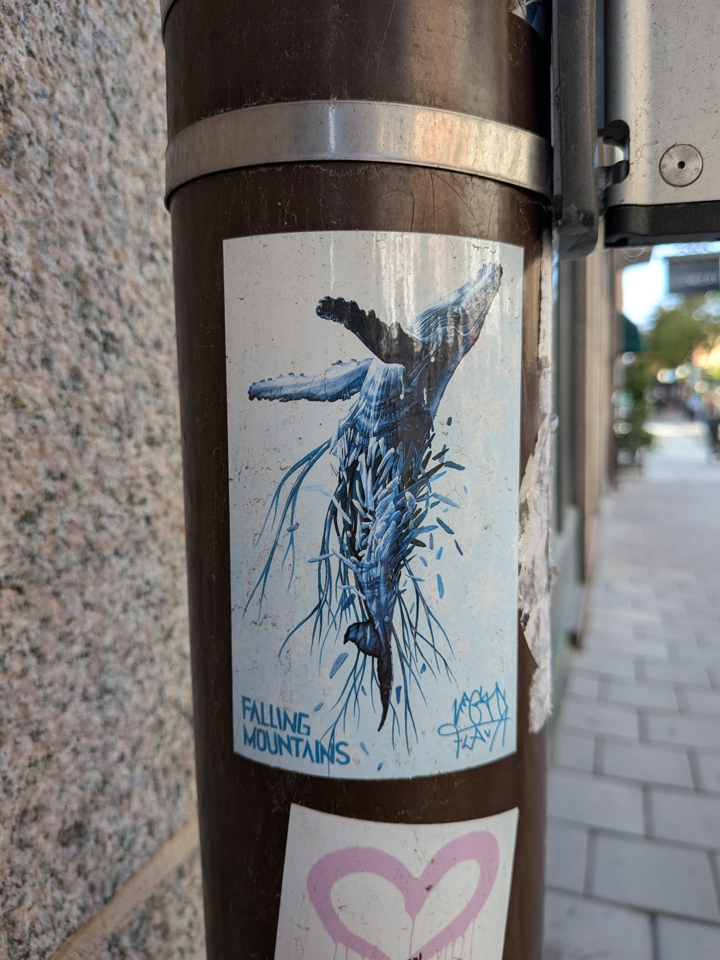 Rectangular sticker depicting a humpback whale diving downwards, its body shattering into blue crystalline shards and root-like tendrils against a pale background with faint snowflake patterns.