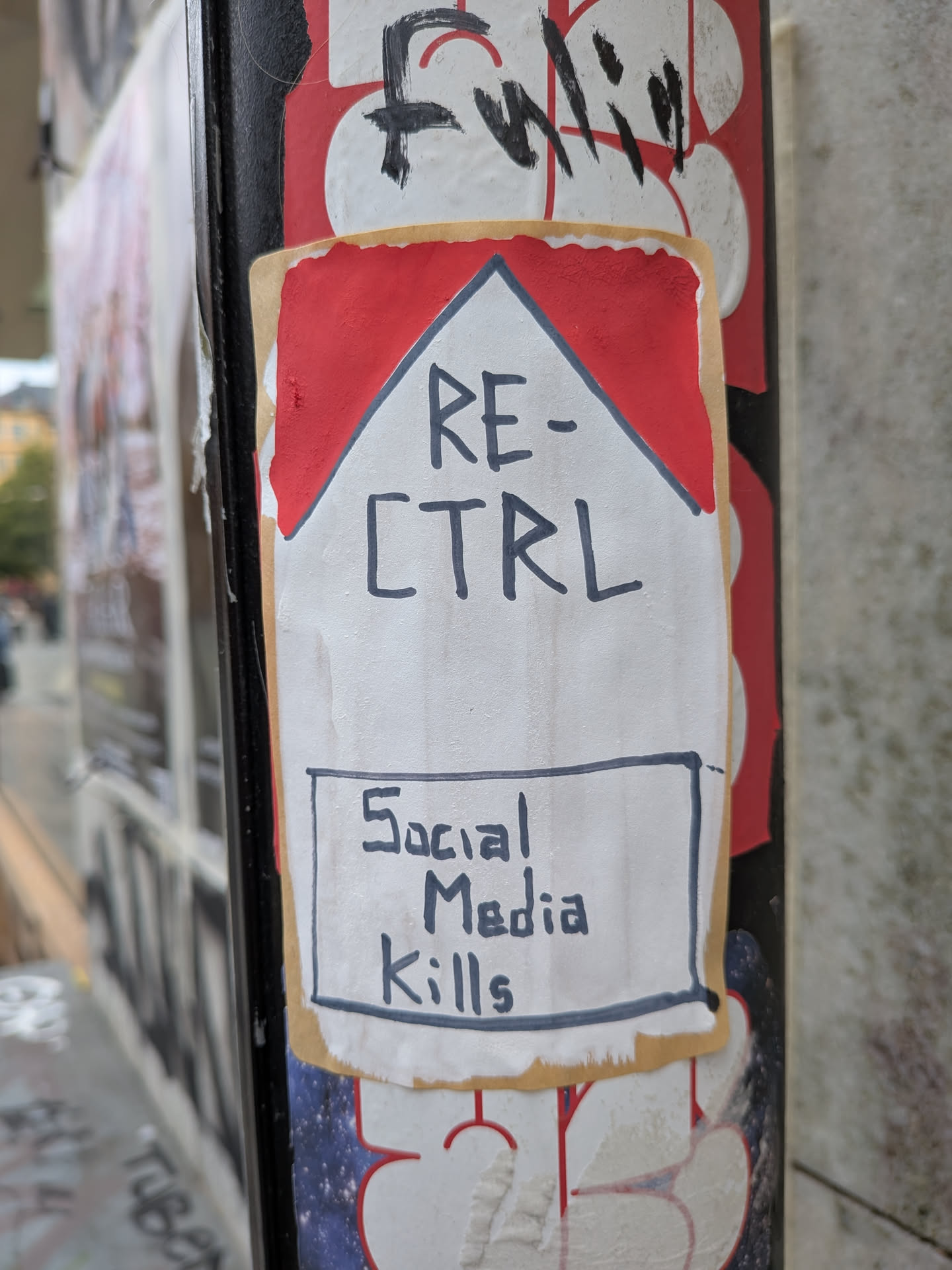 A rectangular sticker designed to resemble a Marlboro cigarette pack. It features a red chevron shape at the top on a white background, with a tan border. The text 'RE-CTRL' is handwritten in black marker in the center. Below it, a hand-drawn black rectangle contains the warning 'Social Media Kills', mimicking tobacco health warnings.
