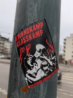 Street sticker The sticker has red text and a black and white image of people rallying. The text reads "Kvinnokamp Klasskamp" at the top and "Revolutionär Kommunistisk Union" at the bottom.
