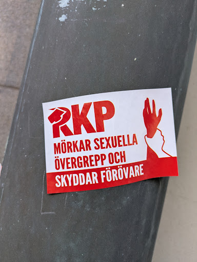 Street sticker The sticker is red and white and features the text "RKP MÖRKAR SEXUELLA ÖVERGREPP OCH SKYDDAR FÖRÖVARE" along with a logo of RKP and a graphic of a hand silencing a face.