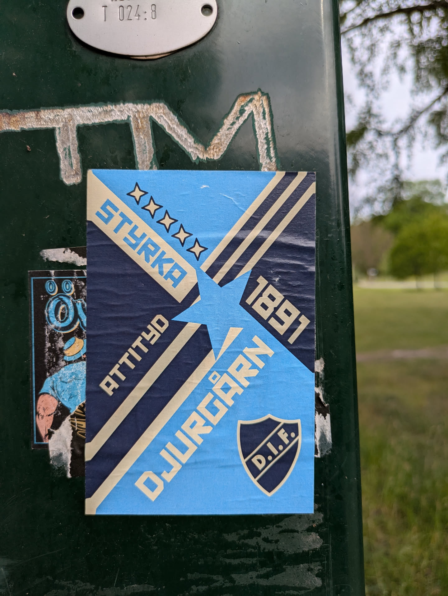 This sticker features the logo of Djurgården IF, a sports club based in Stockholm, Sweden. It has a retro design with the text "STYRKA," "ATTITYD," and "DJURGÅRDEN" along with the year "1891".