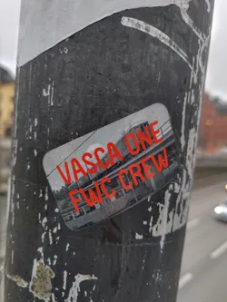 A sticker featuring a grayscale image of what looks like a building or structure, with the text 'VASCA ONE' and 'FWC CREW' in red.